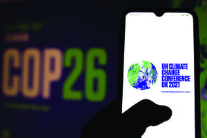 A photo illustration of the 2021 United Nations Climate Change Conference (COP26) logo is seen displayed on a smartphone.