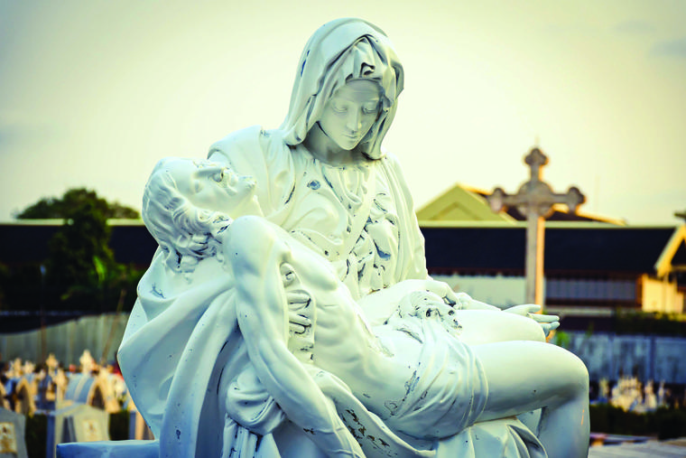 The Blessed Virgin Mary holds the body of Jesus Christ in this cemetery depiction of the Pietà.