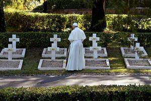 Pope Francis offers prayers before graves at the French military cemetery Tuesday in Rome before offering Mass for All Souls' Day.