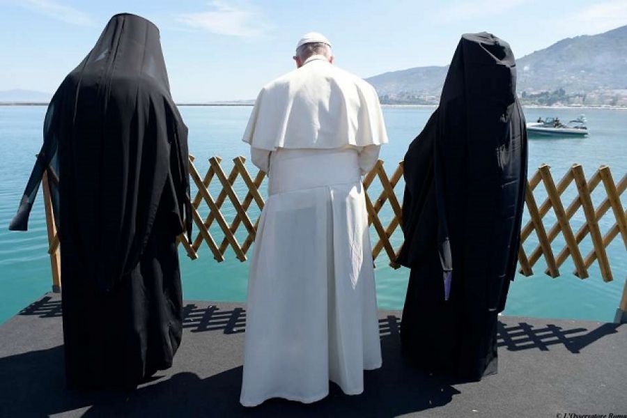 Pope Francis, Patriarch Bartholomew and Archbishop Leronymos look at the sea from Lesbos on April 16, 2016.