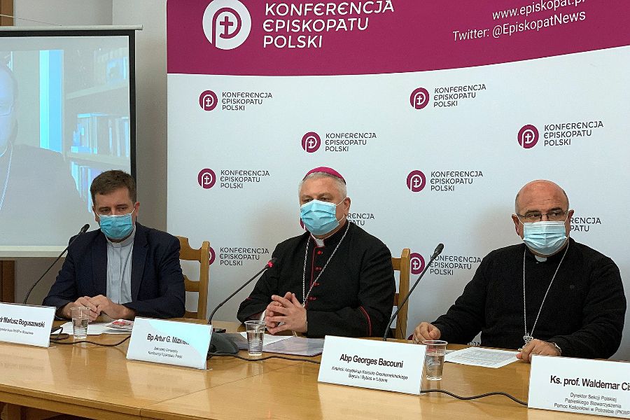 Bishop Artur Miziński and Archbishop Georges Bacouni at a press conference in Warsaw, Poland, Nov. 10, 2021.