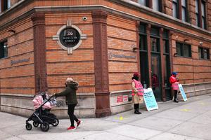 A woman pushes a stroller April 16 past the Planned Parenthood in the Financial District neighborhood of Manhattan in New York City.