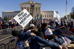 A group of pro-life protesters pray together in front of the U.S. Supreme Court on  Dec. 1 in Washington, as the court hears arguments in a case from Mississippi, where a 2018 law would ban abortions after 15 weeks of pregnancy.