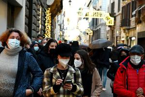 Christmas shoppers walk along the Via Condotti luxury shopping street in central Rome on Dec. 5.