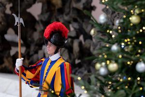 A Swiss Guard stands watch near a Christmas tree in the Paul VI Audience Hall during the Pope’s weekly general audience on Dec. 1.