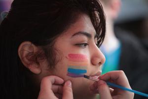 A student gets a rainbow painted on her face at the Columbus Pride Festival on April 14, 2018, in Columbus, Indiana, the hometown of Vice President Mike Pence. The festival was organized by high school senior Erin Bailey.