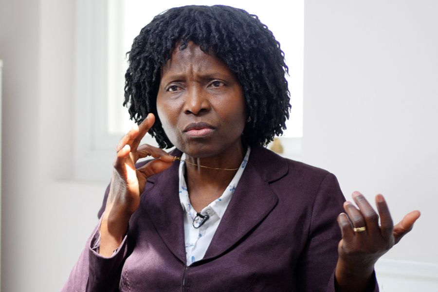 Nurse Mary Onuoha holds the cross on her necklace.