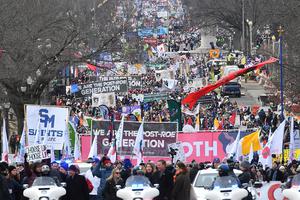A large crowd, some carrying signs saying, “We Are the Post-Roe Generation,” makes its way down Constitution Avenue during the 49th annual March for Life, Jan. 21, 2022, in Washington, DC.