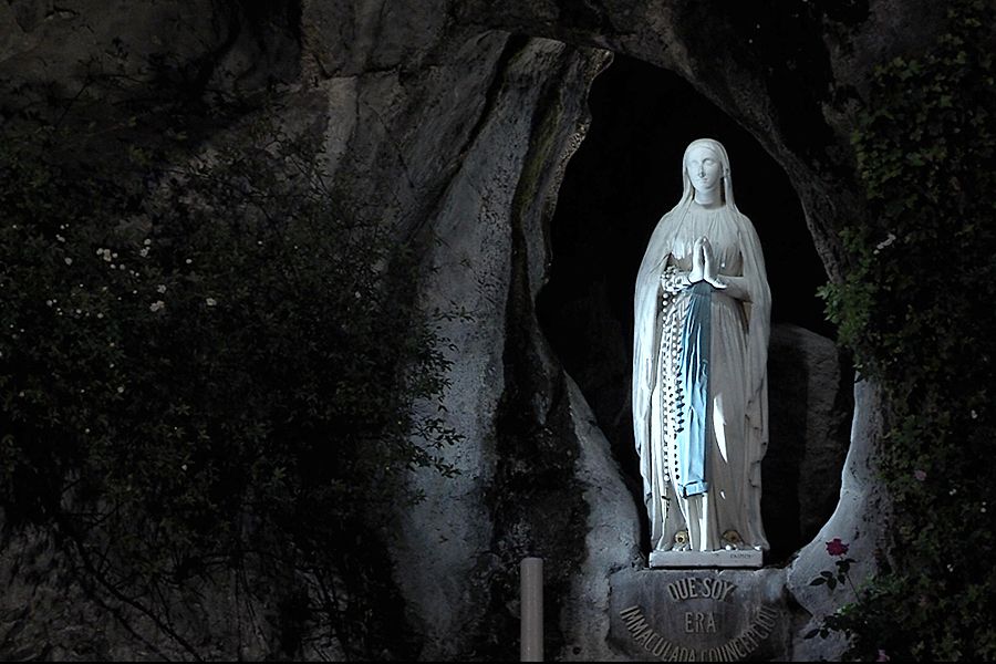 A statue of Mary is displayed at the grotto in Lourdes where Our Lady appeared.