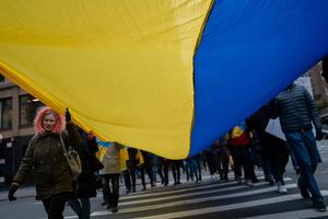 People march in Manhattan with a Ukrainian flag during a rally on Feb. 24 in New York City. Ukrainians, Ukrainian-Americans and allies gathered to show support for Ukraine and protest against the Russian invasion.