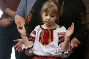 A young girl prays at St. Andrew's Ukrainian Catholic Church in Sydney, Australia, on Sunday.