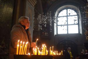 A Ukrainian Catholic faithful prays during a service at the Saints Peter and Paul Garrison Church in the western Ukrainian city of Lviv on March 7, 2022, 12 days after Russia launched a military invasion on Ukraine.