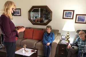 A volunteer minister to the homebound tells a couple that she has small prayer quilts that were made by the Parish Creative Angels for the Homebound.  They were given to each of the homebound visited on March 15 by volunteers of St. Joseph Marello Catholic Church in Granite Bay, California.