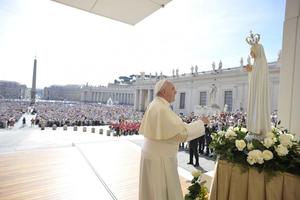 Pope Francis stands in front of a statue of Our Lady of Fatima on the feast day of Our Lady of Fatima, on May 13, 2015, in St. Peter's Square during the Wednesday general audience.