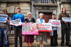 Members of the group ‘Our Lady of Lourdes Protectors’ hold a prayer vigil outside the national maternity hospital in Dublin, Ireland on July 13, 2019.
