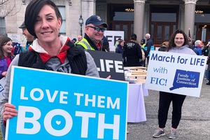 Participants in the 2022 Connecticut March for Life display signs at the state Capitol in Hartford.