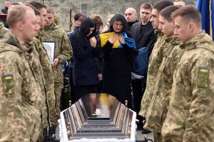 Ukrainian soldiers and family attend the burial of Teodor Osadchyi, a soldier killed during the Russian invasion, at Lychakiv cemetery in Lviv, western Ukraine, on Tuesday. Ukrainian soldiers and family attend the burial of Teodor Osadchyi, a soldier killed during the Russian invasion, at Lychakiv cemetery in Lviv, western Ukraine, on Tuesday.