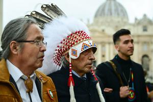 Newly-elected Dene Nation National Chief Gerald Antoine (l) and former national chief of Canada's Assembly of First Nations (AFN), Phil Fontaine (c), escorted by delegation members, arrive to address the media Thursday in St. Peter's Square following a meeting with the Pope.