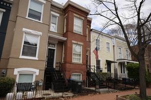 The red-brick row house in the Capitol Hill neighborhood in Washington (c), shown on April 1, is where D.C. Metro Police said they found five aborted babies inside.