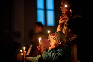People light candles as they celebrate the Holy Saturday Easter vigil in the Catholic Church of St. Mary of Snows in Bratislava, Slovakia, on Easter Eve, April 20, 2019.