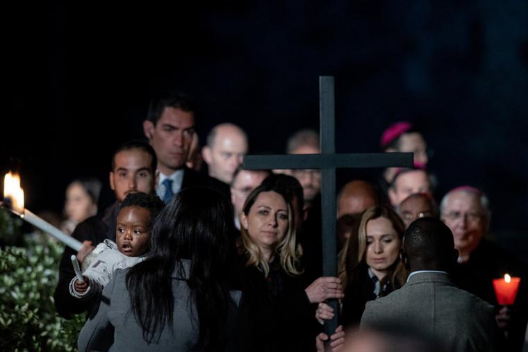 Women from Ukraine and Russia hold the cross at Rome’s Colosseum April 15 during the Vatican's Way of the Cross service.