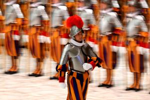 A new Swiss Guard returns to his place after his swearing-in during a ceremony for new recruits of the Pontifical Swiss Guard on Friday in the Paul VI Audience Hall at the Vatican.