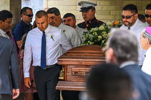 Pallbearers, including U.S. Marine Cristian Garcia, carry the casket of Garcia’s parents, Irma Linda Garcia and Jose Antonio Garcia, after their funeral Mass at Sacred Heart Catholic Church in Uvalde, Texas, on June 1. Irma, a teacher, was killed in the May 24 school shooting, and Joe died two days later of a heart attack.