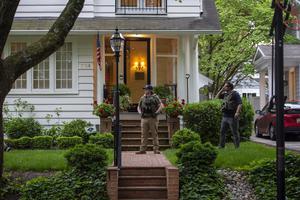 Police officers stand outside the home of U.S. Supreme Court Justice Brett Kavanaugh in anticipation of an abortion-rights demonstration on May 18 in Chevy Chase, Maryland. On June 8, a California man was arrested near the Kavanaugh home and charged with attempted murder of Justice Kavanaugh.