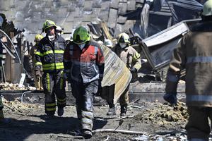 Workers on are seen clearing the rubble of the Amstor mall on June 28, the day after it was hit by a Russian missile strike, according to Ukrainian authorities, in Kremenchuk, Ukraine.