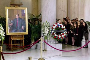 Law clerks and Supreme Court staff watch a private ceremony in the Great Hall of the Supreme Court where Justice Antonin Scalia lies in repose on Feb. 19, 2016, in Washington, DC.