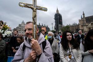 A man holds a crucifix during the March for Life in London. A man holds a crucifix during the March for Life in London.