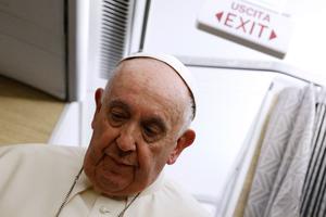 Pope Francis looks down during a news conference aboard the papal plane on his flight back after visiting Canada on July 29.
