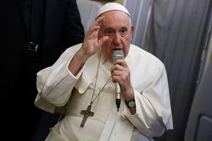 Pope Francis speaks during a news conference aboard the papal plane on his July 29 flight back after visiting Canada.