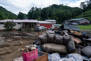 Water-damaged items sit outside a house in Squabble Creek, Kentucky, near Buckhorn, following historic flooding in Eastern Kentucky, July 31, 2022. Water-damaged items sit outside a house in Squabble Creek, Kentucky, near Buckhorn, following historic flooding in Eastern Kentucky, July 31, 2022.