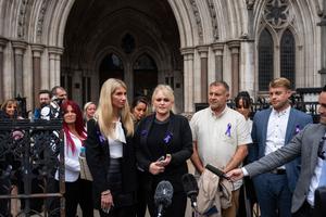 Hollie Dance (C-L) and Paul Battersbee (C-R), the mother and father of Archie Battersbee, speak to the media as they leave the Royal Courts of Justice after winning an appeal for his case to be heard again, on June 29, 2022 in London, England.