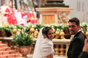 A bride and bridegroom stand before the high altar of St. Peter’s Basilica as Pope Francis conducts a wedding ceremony for 20 couples on Sept. 14, 2014. A bride and bridegroom stand before the high altar of St. Peter’s Basilica as Pope Francis conducts a wedding ceremony for 20 couples on Sept. 14, 2014.