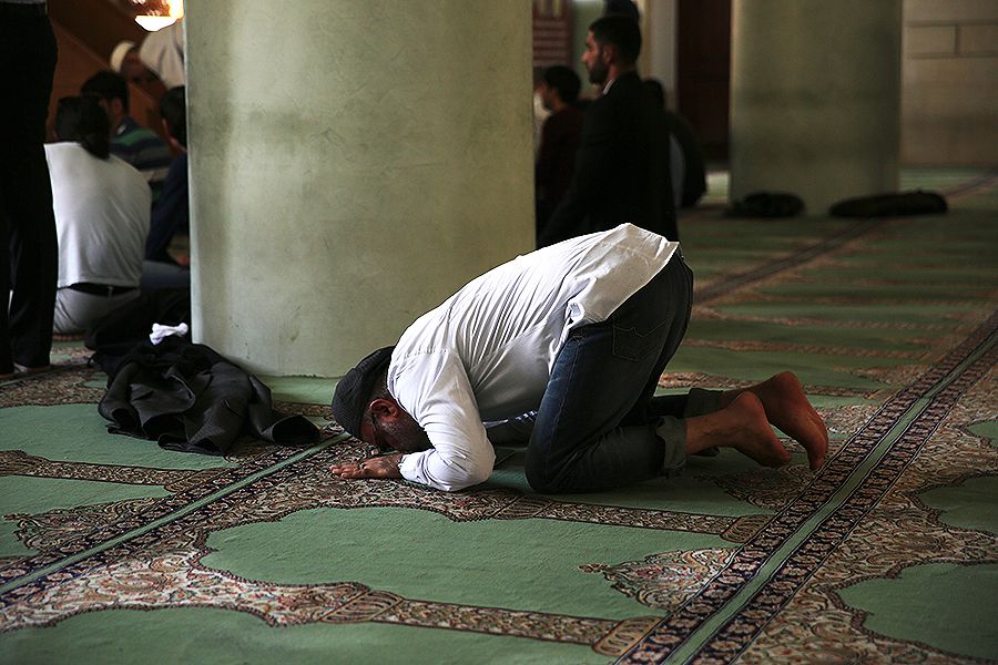 A man prays at a mosque.