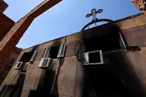 A picture shows the damage at Abu Sifin Church, located in the densely populated Imbaba neighborhood west of the Nile River, part of Giza governorate, on Aug. 14; more than 40 people were killed when a fire ripped through the Coptic Christian church. A picture shows the damage at Abu Sifin Church, located in the densely populated Imbaba neighborhood west of the Nile River, part of Giza governorate, on Aug. 14; more than 40 people were killed when a fire ripped through the Coptic Christian church.