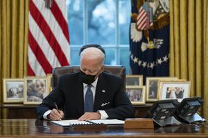 President Joe Biden signs an executive order reversing the Trump-era restriction on transgender individuals serving in military, Jan. 25, in Washington. Five days earlier, he signed an executive order that directed federal agencies to enforce laws to prohibit discrimination based on sexual orientation and gender identity in areas including (but not limited to) employment, housing, health care, education and credit.