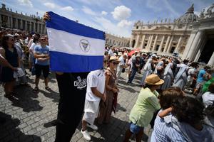 A man holds the national flag of Nicaragua at St. Peter's square during the Pope's weekly Angelus prayer on August 21, 2022 in The Vatican.