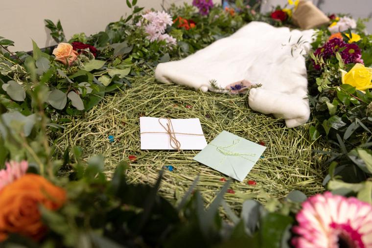 A demonstration "vessel" for the deceased, which has been decorated with flowers and compostable mementos by Return Home on top of a bed of straw, is pictured during a tour of the funeral home which specializes in human composting in Auburn, Washington on March 14, 2022.