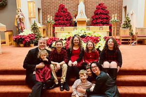 Mark Houck and his family pose for a photo during Christmas in front of the altar.