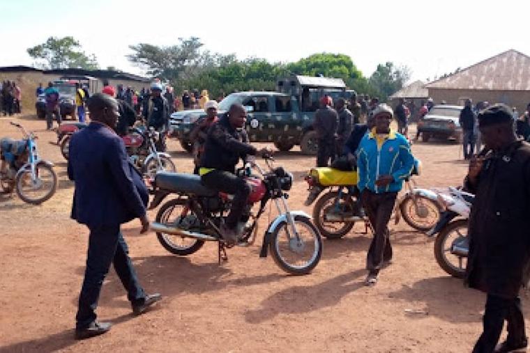 Police and residents of Wumat, a farming town 45 miles south of Jos, Nigeria, arrive to survey damage and help survivors of a terrorist attack on Nov 22, 2022.