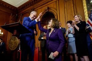 House Speaker Nancy Pelosi, D-Calif., high fives Senate Majority Leader Chuck Schumer, D, N.Y., as Sen. Susan Collins, R-Maine, and Sen. Tammy Baldwin, D-Wisc., look on during a bill enrollment ceremony for the so-called 'Respect For Marriage Act' at the U.S. Capitol Building on December 08, 2022 in Washington, DC. In a 258-169 vote the House of Representatives passed the act.