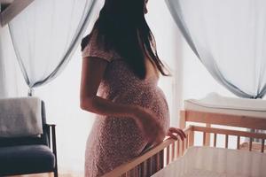 A pregnant mother prepares her baby's nursery. A pregnant mother prepares her baby's nursery.