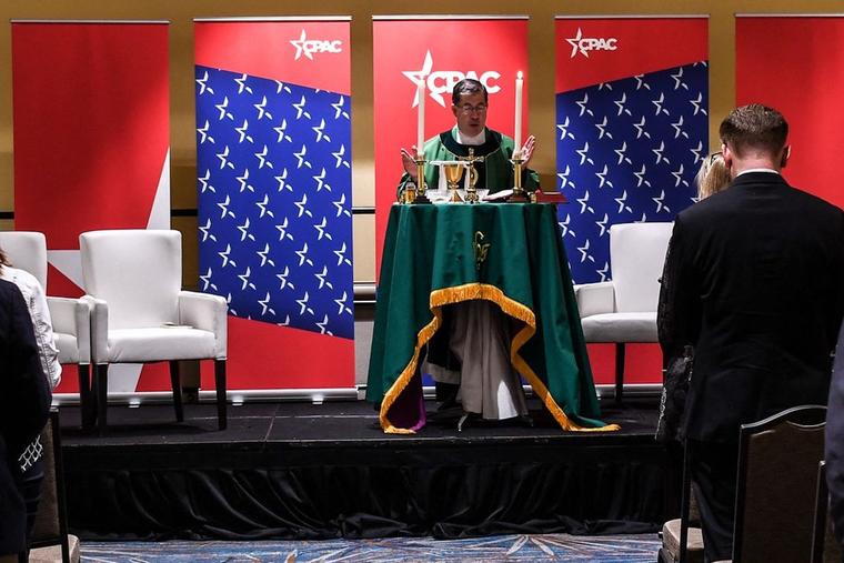 People attend Catholic Mass with Father Frank Pavone at the Conservative Political Action Conference 2022 (CPAC) in Orlando, Florida on February 24, 2022. 