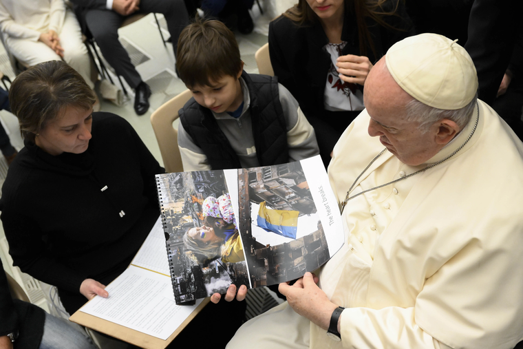 Pope Francis looking at images from Ukraine at the general audience, Dec. 21, 2022