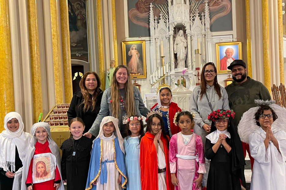 Mrs. Kovaleski poses with her class on All Saints' Day. 