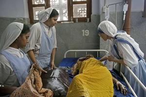 Missionaries of Charity care for a patient at Nirmal Hriday, a hospice for the sick, destitute and the dying, on Aug. 30, 2016, in Kolkata, India. Missionaries of Charity care for a patient at Nirmal Hriday, a hospice for the sick, destitute and the dying, on Aug. 30, 2016, in Kolkata, India.