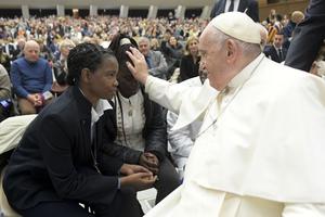 Pope Francis blesses a young woman during a general audience in the Vatican's Paul VI Hall in December 2022. Pope Francis blesses a young woman during a general audience in the Vatican's Paul VI Hall in December 2022.